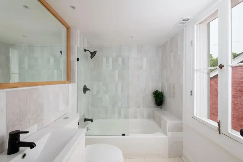 Marble-tiled bathroom with soaking tub, 1880s Glam