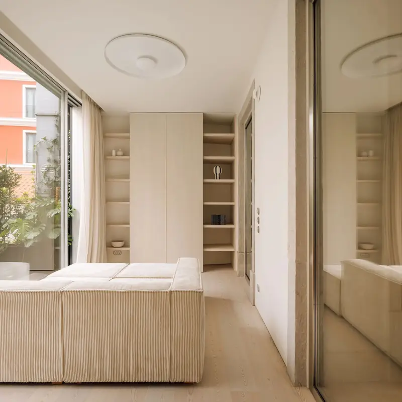 Minimalist bedroom with pale wood floors and built-in storage, Apartment CK
