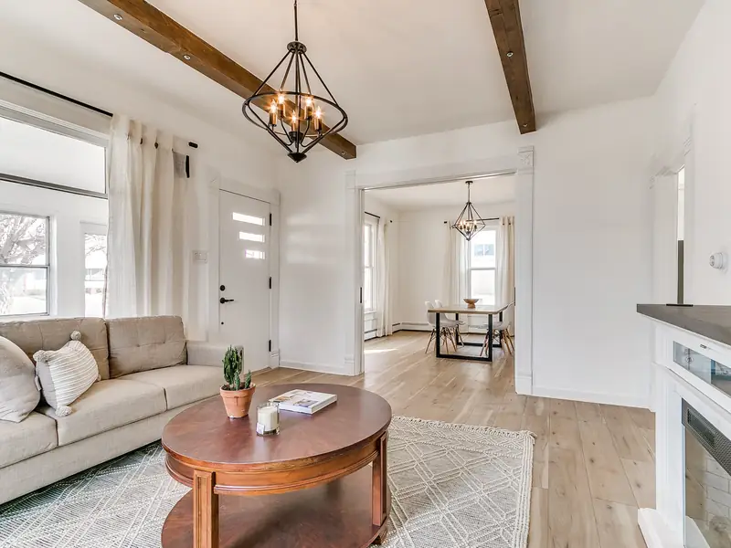 Living room with exposed wood beam and round coffee table