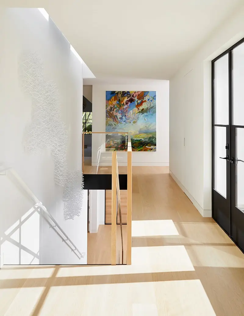 Sunlit stone hallway with artwork, Stone Haven